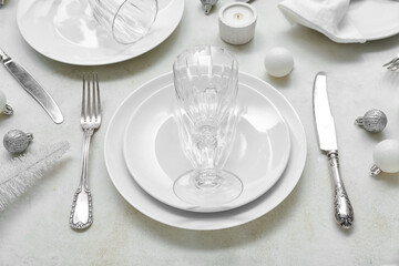 Beautiful table setting with Christmas balls on white background, closeup