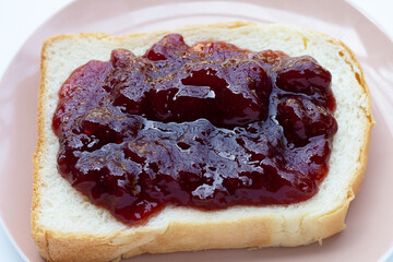 Sliced bread with strawberry jam