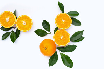 Orange fruit with green leaves on white background.