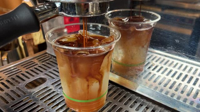 Iced long black in a take away biocup, plant-based bioplastic, certified industrially compostable to Australian standard, sustainability concept.