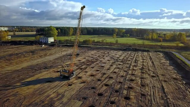 Crawler Crane Doing A Dynamic Compaction Method, By Tamping Using A Heavy Steel And Concrete Weight. - aerial
