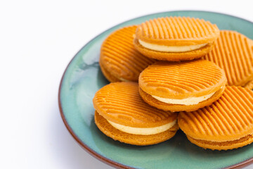 Custard cream sandwich biscuits on white background.