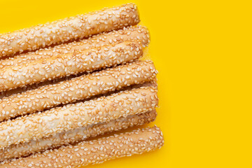 Bread sticks on yellow background