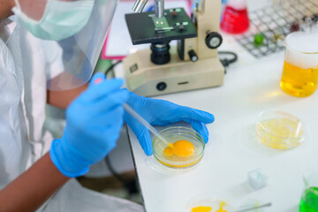Modern Medical Research Laboratory: Stem cell researcher working in laboratory Study on Stem Cells on the Stereo microscope view in laboratory , Advanced Scientific Lab for Medicine, Biotechnology.