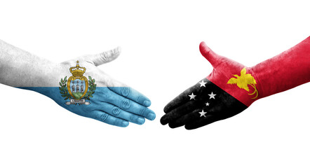 Handshake between Papua New Guinea and San Marino flags painted on hands, isolated transparent image.