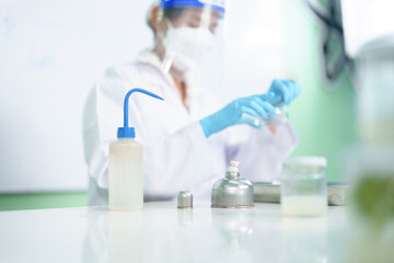 Fototapeta premium Scientists research results in natural medicine, organic extraction natural science in glassware, alternative green herbal medicine, natural skin care products, laboratories and development concepts. 