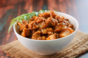Cooked tapioca and spicy meat curry , Cassava root , Mandioca or Aipim, Kerala special Kappa Puzhukku or Kappa biryani South Indian food beef tapioca, India. with Fish curry. root vegetable Brazil