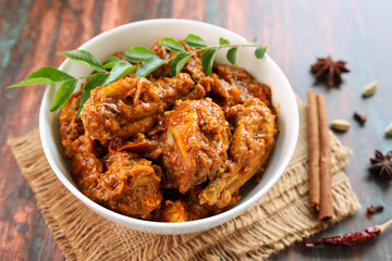 Masala Chicken curry with Appam Kerala breakfast , Hoppers pan cake , homemade chicken roast Indian spices , Asian cuisine spicy meat curry cooked in coconut milk . side dish Christian food Christmas