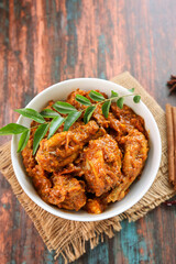 Masala Chicken curry with Appam Kerala breakfast , Hoppers pan cake , homemade chicken roast Indian spices , Asian cuisine spicy meat curry cooked in coconut milk . side dish Christian food Christmas