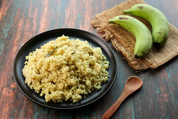 Upma, Uppittu green banana and Kadala curry Kerala breakfast food on dark black background Tamil Nadu South India. Made with Rava or semolina.	