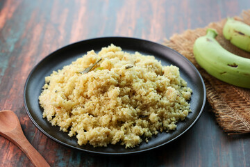 Upma, Uppittu green banana and Kadala curry Kerala breakfast food on dark black background Tamil Nadu South India. Made with Rava or semolina.	