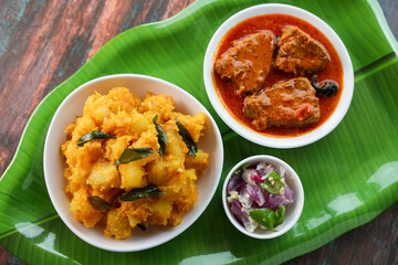 tapioca and spicy hot Kerala fish curry Indian food. Kappa king fish masala curry. Asian cuisine Bengali macher Jhal Goan fish curry in coconut milk Cassava root , Mandioca Sri Lanaka Tamil nadu