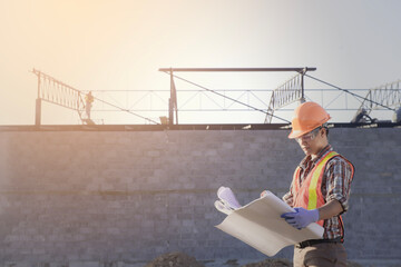 Worker with  safety vest and  safety helmet hold the blue print working at site line , new construction design and audit process