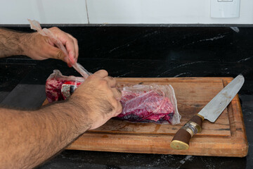 Brazilian flank steak, vacuum-sealed beef on a wooden board