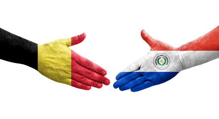 Handshake between Paraguay and Belgium flags painted on hands, isolated transparent image.