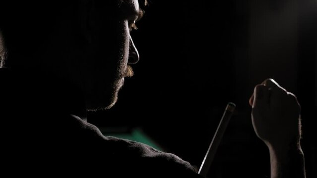 Man wipes a cue with chalk ready to start game. Pool room on the background. Handsome bearded man rubbing cue with chalk at bar. Slow motion.