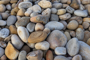 Fototapeta na wymiar Pebble stone over the sea beach background