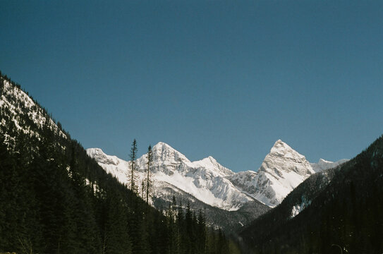 snow covered mountains in the canadian rockies, shot on 35mm film on a vintage analog camera