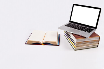 Laptop and book isolated from background. You can change the background freely. communication network. silver metal surface. digital modern communication computer technology