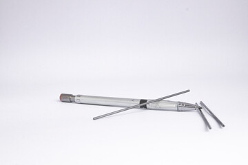 One mechanical pencil and three pencil lead