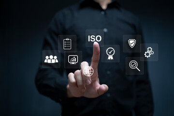 ISO Certification of standards quality control assurance business technology concept. Businessman using virtual screen iso certification icon to guarantee.