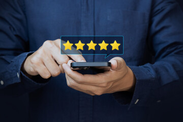 Customer holding smartphone giving a five star rating with rating feedback scale on blue...