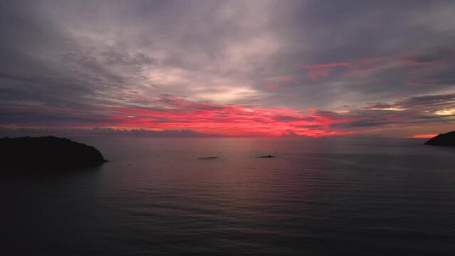 Dolly shot of the vibrant sunset setting over Pentai Tengah Beach, Malaysia