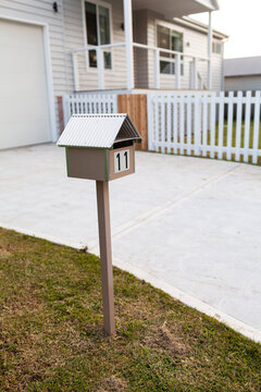 Urban mailbox with number 11 in front of new house