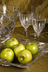 Table setup with green apples and crystal