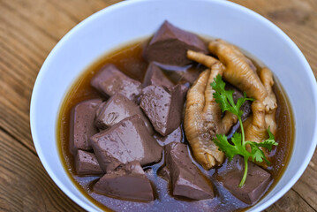 chicken blood, Thai food chicken feet soup stewed, cooking chicken feet foot stew on white with herbs and spices ingredients with chilli lemon vegetable on wooden background, Asian chinese food menu