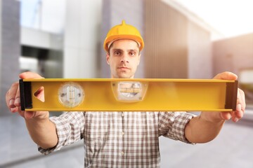 Young male builder working at construction