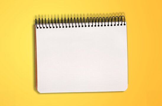 Blank classic desk notebook on color background.