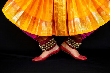 Female Indian classical dancer legs in closeup view demonstrating dance mudra or gestures.