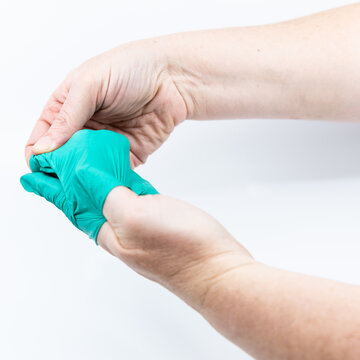 Safely removing green surgical gloves