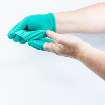 Safely removing green surgical gloves