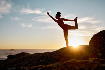 Fitness, woman and yoga stretching on the beach during sunset for spiritual wellness, training or...