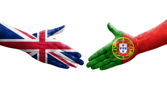 Handshake between Portugal and United Kingdom flags painted on hands, isolated transparent image.