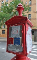 A red fire alarm box for fire or police in New York, NY, USA. August 28, 2022.