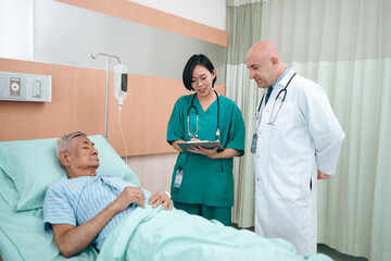 Fototapeta premium professional doctor standing by explain the treatment information via male elderly patient lying in bed in private hospital sickroom. The treatment program is suitable for people to socialize elderly
