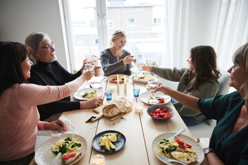 Family raising toast during dinner