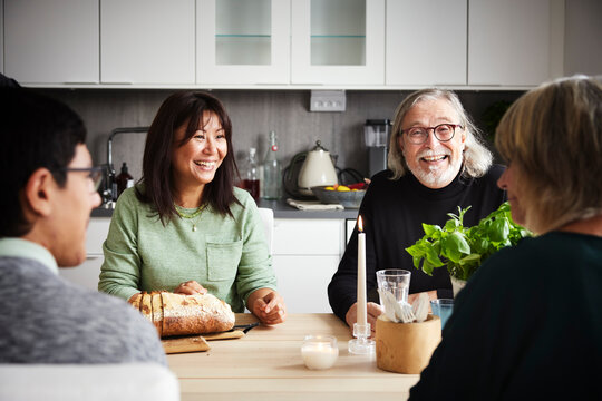 Family sitting at table and having conversation