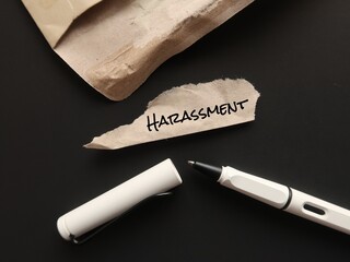 Torn office envelope with pen writing a word HARASSMENT, means illegal  Persistent attacks and...