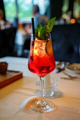 classic aperol cocktail at the bar, Classic italian aperol spritz cocktail in glass on dark . Close up drink menu concept.