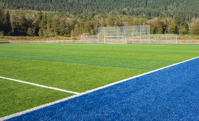 Football Field. Photo of a green synthetic grass sports field with white line