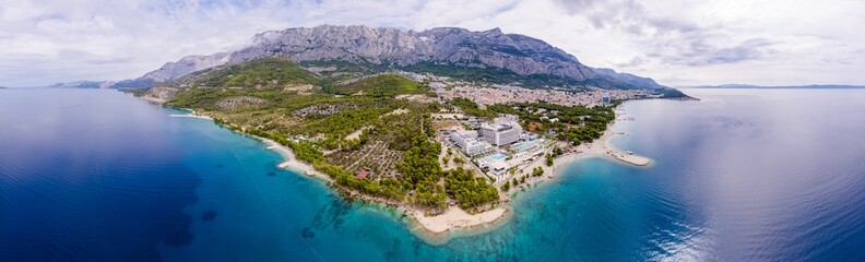 Town of Breal beach and Biokovo mountain aerial panoramic view, Makarska riviera in Dalmatia,...