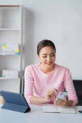 Closeup asian woman holding gold credit card and smartphone, sitting at home, happy satisfied young female customer shopping online, purchasing, making secure online payment.