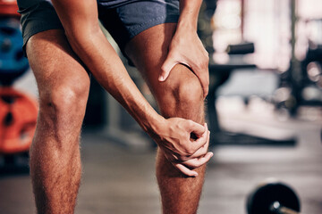 Fitness, exercise and man with knee pain in gym holding leg after injury, accident and muscle pain....