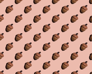 Seamless pattern of identical acorns on a beige background. Autumn print for wallpaper, background. Design for wrapping paper, fabrics, covers and postcards.