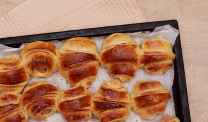 appetizing baked croissants with sausages close-up