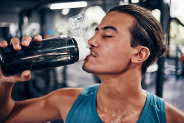 Drinking water, fitness and gym man with challenge workout training for muscle, power and energy...